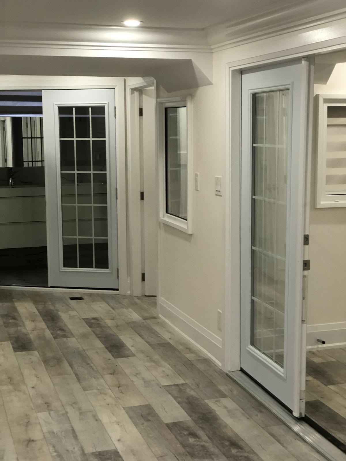 Kitchen renovation with custom cabinetry, island seating, and modern lighting